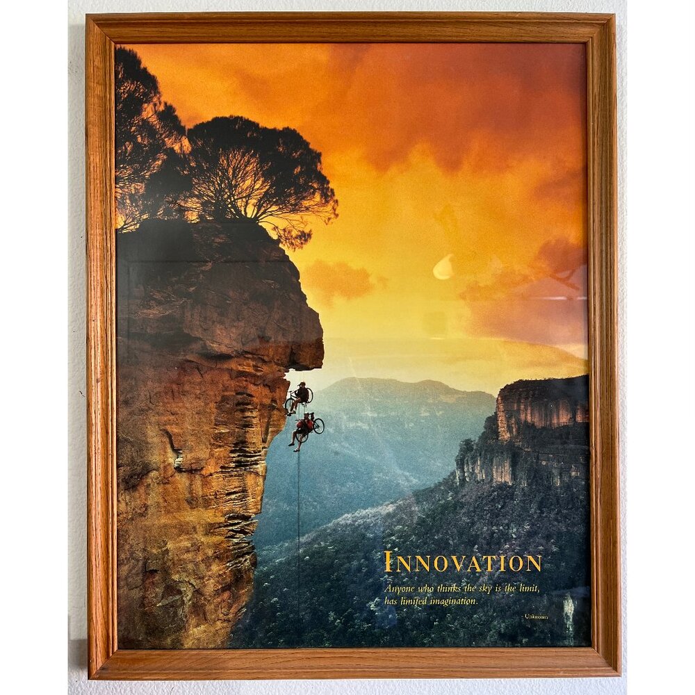 Innovation Art Inspirational poster framed in a wood frame.